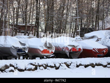 Sailing boats packed for the winter with snow Stock Photo