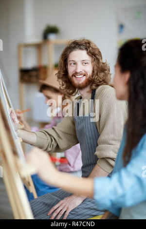 Guy talking to groupmate Stock Photo