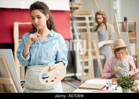 Artist by easel Stock Photo