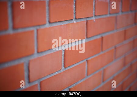 Perspective of a red brick wall, selective focus. Stock Photo