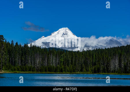 Mount Hood covered with snow and clouids against a blue sky from Frog Lake, Oregon, USA. Stock Photo