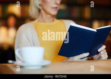 Reading in coffee shop Stock Photo