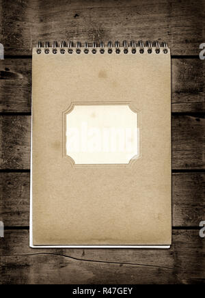 Closed spiral Note book on a dark wood table Stock Photo