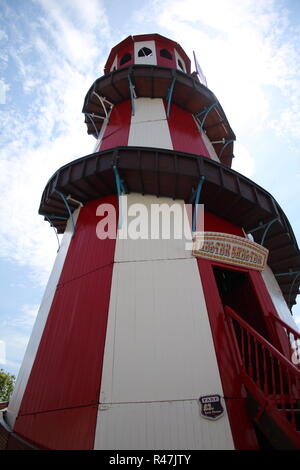Wooden Helter Skelter. Red and white against clouds and blue sky in Llandudno, North Wales. Stock Photo