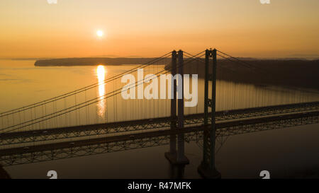 Traffic pays to cross the bridge in one direction as the afternoon fades over Puget Sound in Washington Stock Photo