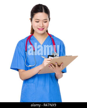 Doctor take note on clipboard Stock Photo