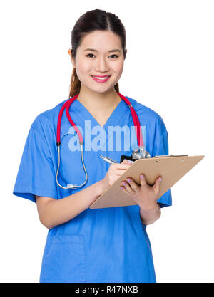 Asian doctor take note on clipboard Stock Photo