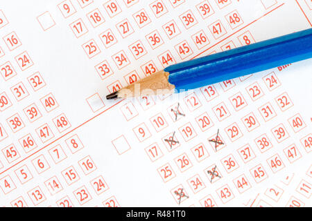 Marking numbers  on lottery ticket Stock Photo