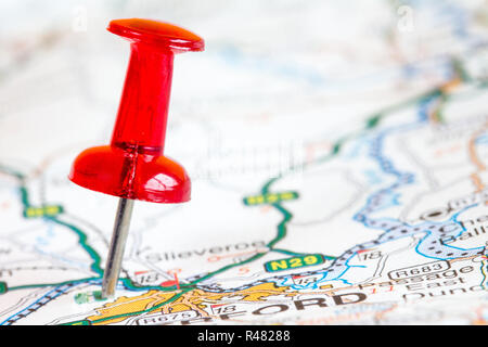 Red pushpin on a tourist map