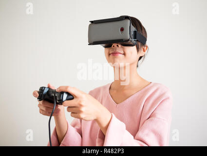 Asian Woman wearing virtual reality headset Stock Photo