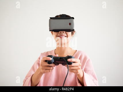 Woman playing though vr device with joystick Stock Photo