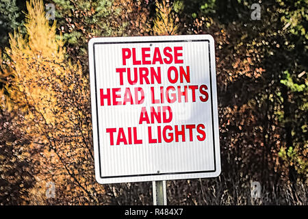 A sign indicating to turn on all vehicle lights Stock Photo