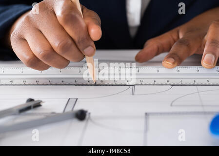 Person's Hand Drawing Blue Print Stock Photo