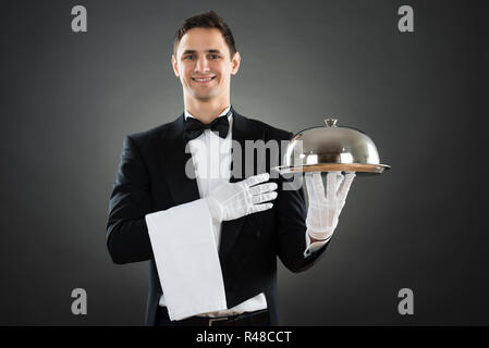 Portrait Of Happy Waiter With Tray And Towel Stock Photo