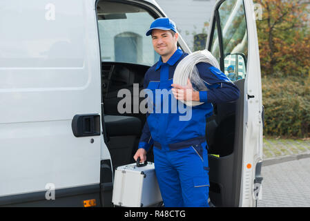 Confident Technician With Cable Coil And Toolbox Stock Photo