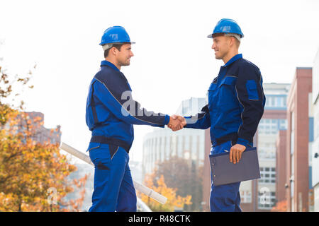 Architects Shaking Hands Outdoors Stock Photo