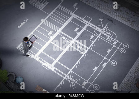 Man engineer thinking over his plan. Mixed media Stock Photo