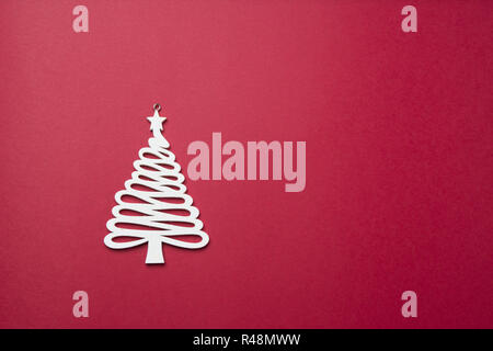 Christmas decoration, a white christmas tree decoration on a rd purple background, top view, flat lay. Stock Photo