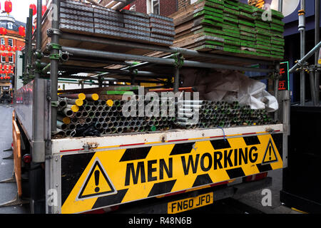 Men Working warning sign on the back of a Lorry in Soho, london Stock Photo