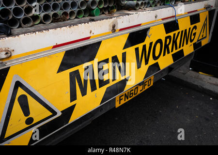 Men Working warning sign on the back of a Lorry in Soho, london Stock Photo