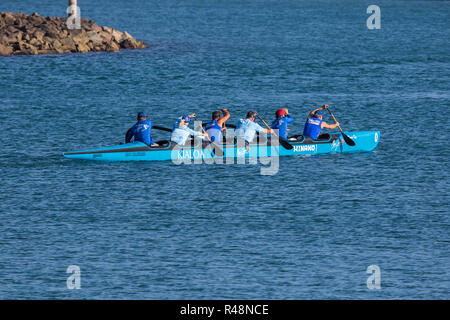 Outrigger canoe crew paddling inside the harbor at Dana point California ; USA Stock Photo