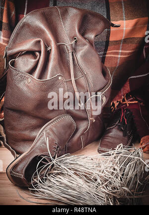 Leather products against the background of wool tartan Stock Photo