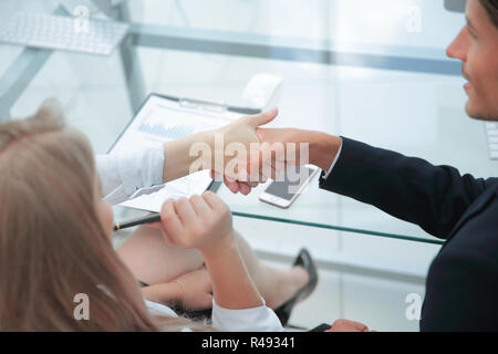 rear view .handshake financial partners after the discussion of the business plan Stock Photo