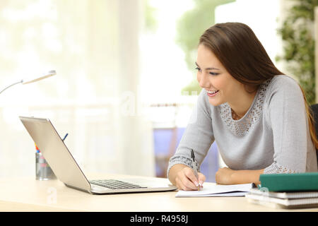 Student studying with laptop and notes Stock Photo