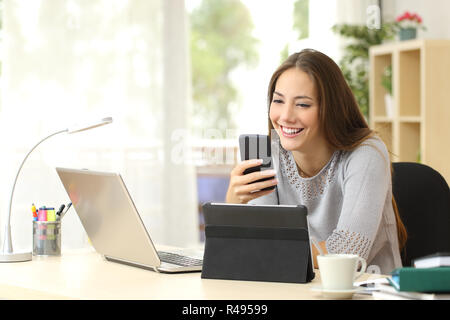 Woman using multiple devices at home Stock Photo