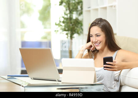 Woman working with multiple devices Stock Photo