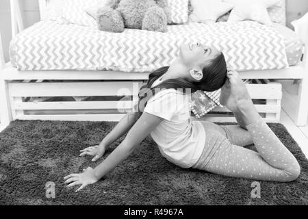 Morning exercises. Cute gymnast practice stretching every morning. Girl  child stretching on carpet. Time for morning stretching. Girl kid long hair  cute pajamas relaxing and stretching Stock Photo - Alamy