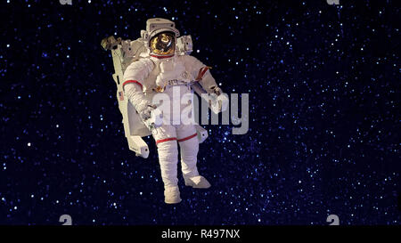 An astronaut in spacesuit floating in the blackness of space against a background of stars Stock Photo