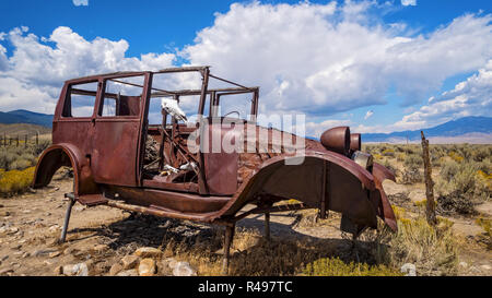 Rusted antique car and cow skull sit in the desert at Great Basin National Park in eastern Nevada Stock Photo