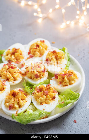 Healthy Deviled Eggs as an Appetizer with Bacon Stock Photo