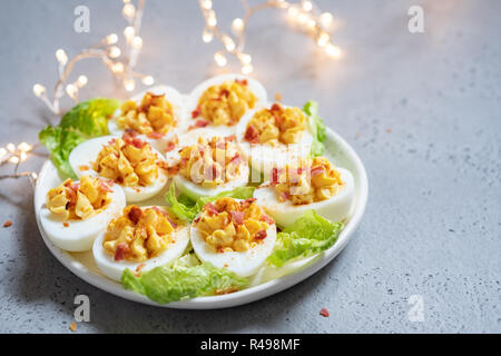 Healthy Deviled Eggs as an Appetizer with Bacon Stock Photo
