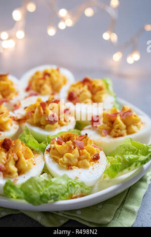 Healthy Deviled Eggs as an Appetizer with Bacon Stock Photo