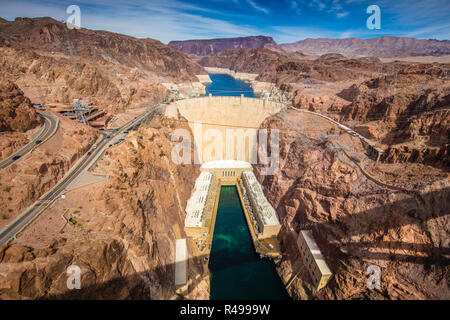 Aerial wide angle view of famous Hoover Dam, a major tourist attraction located on the border between the states of Nevada and Arizona, on a beautiful Stock Photo