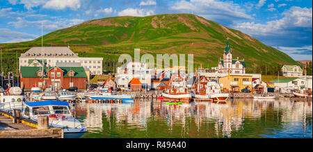 Scenic view of the historic town of Husavik in beautiful golden evening light at sunset with blue sky and clouds, north coast of Iceland Stock Photo