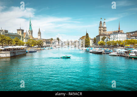 Panoramic view of Zurich city center with churches and boats on beautiful river Limmat in summer, Canton of Zurich, Switzerland Stock Photo