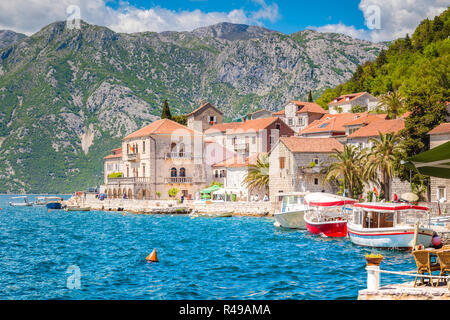 Historic town of Perast at famous Bay of Kotor with on a beautiful sunny day with blue sky and clouds in summer, Montenegro, Balkans Stock Photo