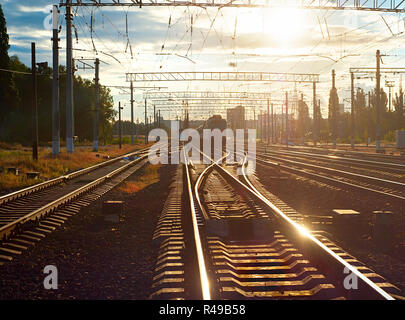 Train on railroad at sunset Stock Photo