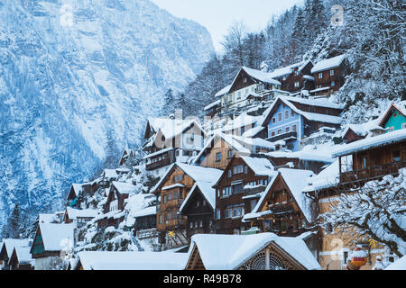 Classic postcard view of traditional wooden houses in famous Hallstatt lakeside town in the Alps in mystic twilight during blue hour at dawn on a beau Stock Photo