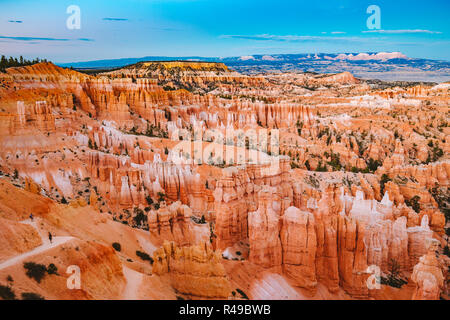 Classic view of Bryce Canyon National Park in beautiful golden evening light at sunset with blue sky and dramatic clouds seen from famous Sunset Point Stock Photo