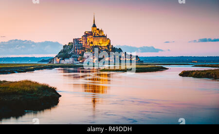 Classic view of famous Le Mont Saint-Michel tidal island in beautiful evening twilight at dusk, Normandy, northern France