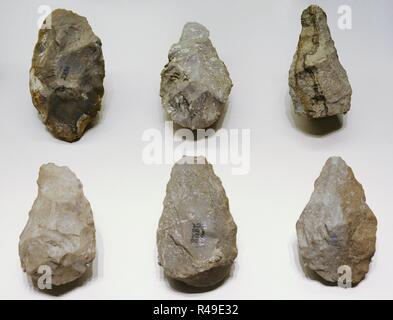 Stone tools including chopping tools, hand-axes, picks and spheroids, from  the Acheulean industry. Acheulean refers to an archaeological industry of  stone tool manufacture characterized by distinctive oval and pear-shaped  'hand-axes' associated with