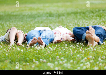 Happy young Family lying on grass Stock Photo