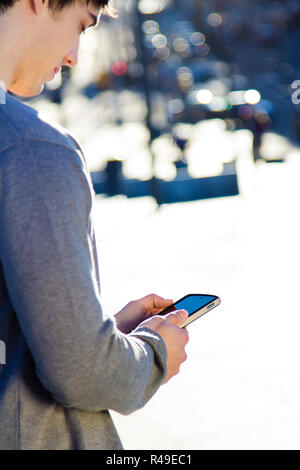 Young man chatting with their smartphone Stock Photo