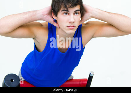 young man practicing sport in gym Stock Photo