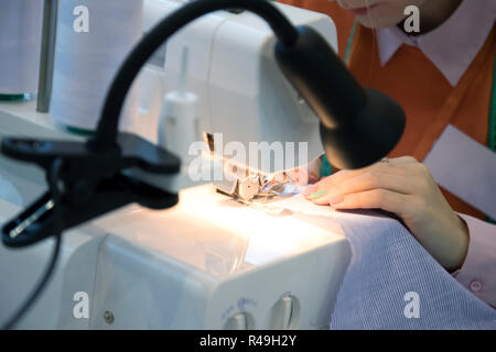 Woman using sewing machine, closeup Stock Photo