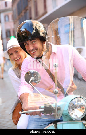 Cheerful couple in Rome riding scooter Stock Photo